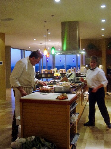 Image of Chef in Kitchen with view of dining room   
